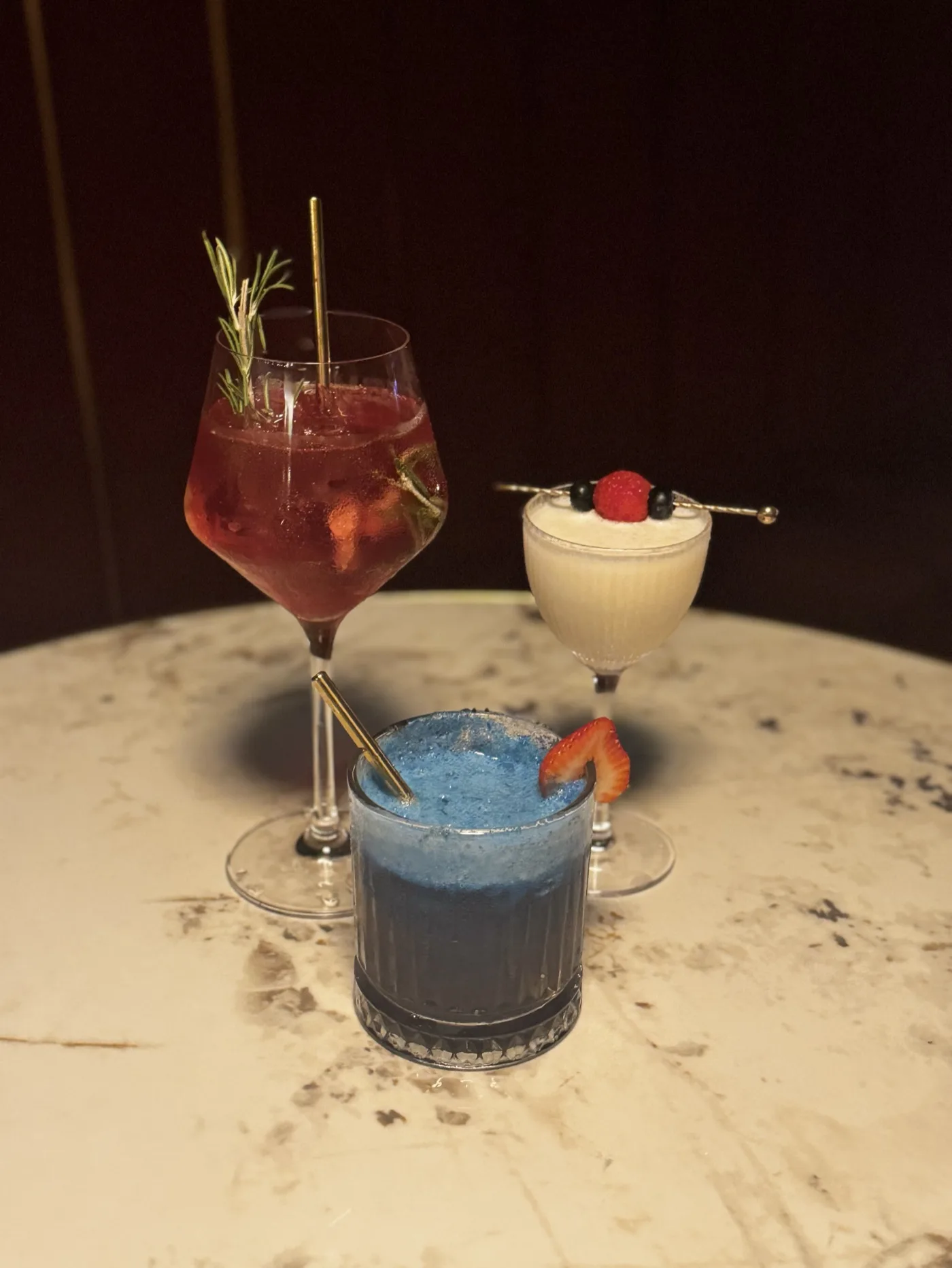 Three craft zero-proof cocktails on a marble table at Sober Bar